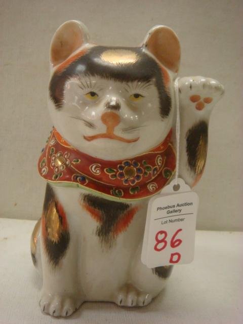 Antique Kutani Maneki-Neko Stoneware Japanese Cat:: Antique Kutani Maneki-Neko Stoneware Japanese Cat: Hand Painted Black, Orange and Gold Spots on White Cat. Red Collar and Bib with Moriage Slip. 5 1/2"T. (300-400)