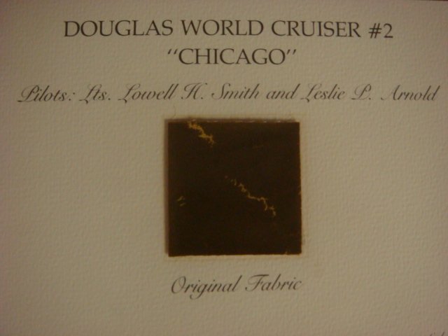 Fabric from DOUGLAS WORLD CRUISER #2 "CHICAGO":: Fabric from DOUGLAS WORLD CRUISER #2 "CHICAGO": 2"x 2" Piece of Original Fabric from 1st Airplane to Circumnavigate the Earth. Flown By Lts.. L.K. Smith & L.P. Arnold, Departed Seattle on April 16, 19