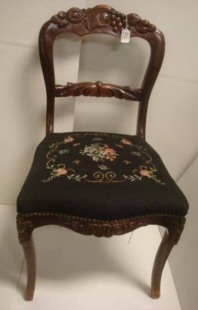 Carved Mahogany Victorian Side Chair, Needlepoint: Carved Mahogany Victorian Side Chair, Needlepoint Seat: Floral, Foliage & Berry Carved Crest Rail, Leaves Repeated on Horizontal Cross Bar. Carved Apron and Knees of Shaped Legs. Floral Needlepoint on