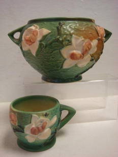 ROSEVILLE MAGNOLIA Cup and Double Handled Bowl:: ROSEVILLE MAGNOLIA Cup and Double Handled Bowl: White Magnolia Blossoms on Black Stems with Green Background. Bowl has Small Chip on Rim, #665-5", Cir 1943. Vase #3-3, Cir 1940. (20-50)