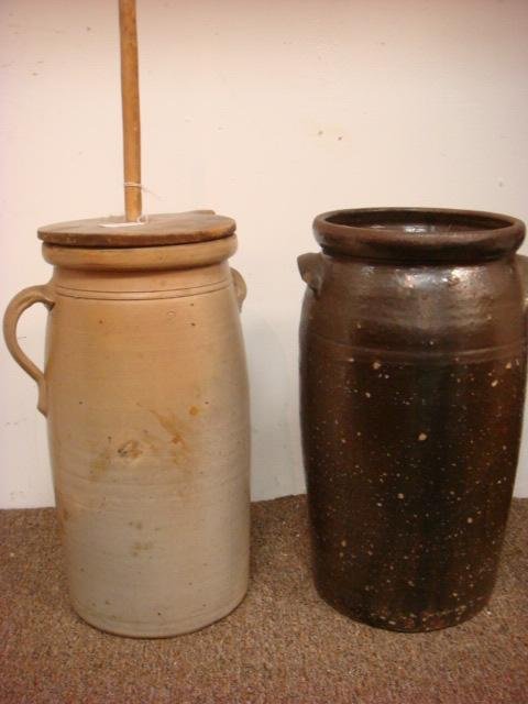 Two Stoneware Butter Churns, One with Lid, Dasher:: Two Stoneware Butter Churns, One with Lid, Dasher: Three Gallon Churn with Single Handle, Wooden Dasher and Lid. Primitive Piece is 16"T. Continuous Crack Down Side. 4 Gallon Brown Alkaline Glaze, Str