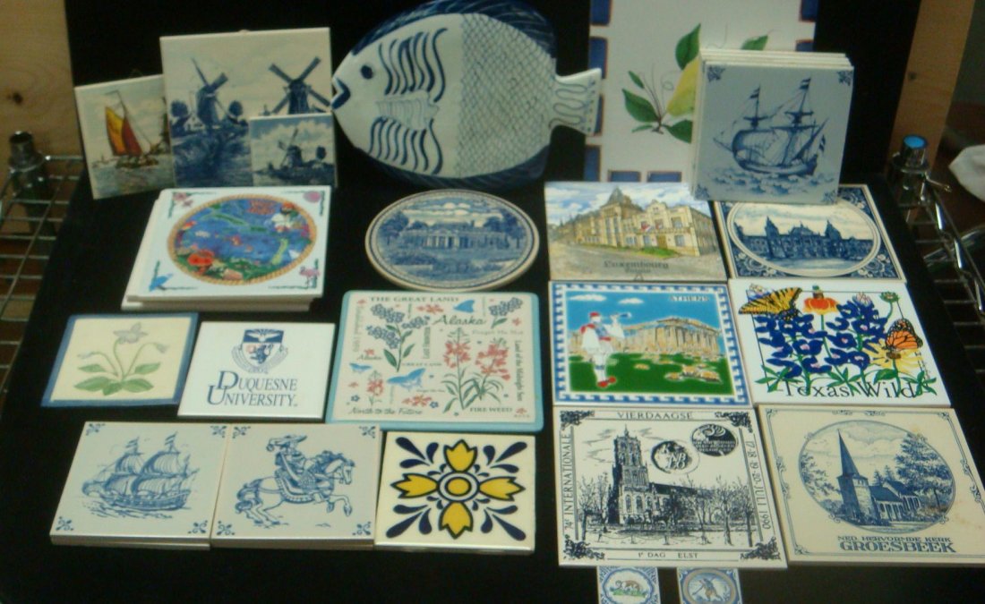Collection of Porcelain Tiles and Trivets:: Collection of Porcelain Tiles and Trivets: Monticello, Amsterdam, Luxembourg, Alaska, Athens, Grossbeek, Duquesne U., West Indies, Sailboats and Windmills (30-100)