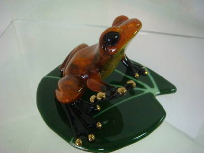 TIM COTTERILL BRONZE FROG "HIGH FOUR" Figurine:: TIM COTTERILL BRONZE FROG "HIGH FOUR" Figurine: Includes Glass Lillypad. Rust Colored Frog Reaching Out For A High Four. Released 2004, 2501/5000. 2 1/4"T x 4"W Lillypad is Made of Green Glass; 4