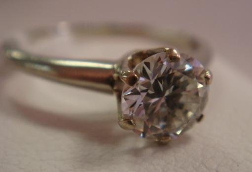 Ladies 18K White Gold Diamond Solitaire Ring:: Ladies 18K White Gold Diamond Solitaire Ring: One Round Brilliant Cut Diamond, .95CT, Secured in 6 Prong Mounting. Color GH, Clarity VVS2. Polished Slightly Tapered Band. Gross Weight 3.0 Grams. Size 