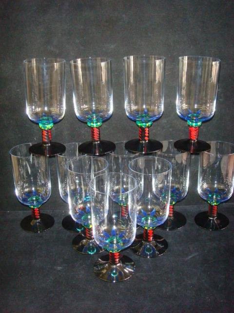 Twelve KOSTA BODA Ken Done Palm Trees Beer/Tea Stems:: Twelve KOSTA BODA Ken Done Palm Trees Beer/Tea Stems: Ca 199-2003. Handpainted Stems by Ken Done Australian Artist. Etched on Bottoms Kosta Boda Den Done 24209. 7 1/8"T. Amethyst Foot and Stem. Signed