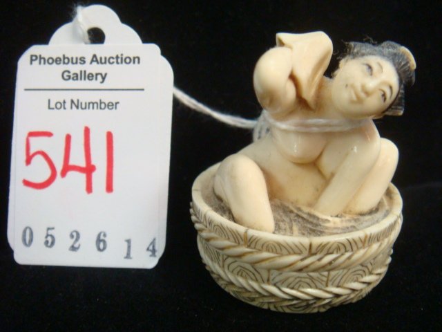SIGNED JAPANESE IVORY CARVED NETSUKE:: SIGNED JAPANESE IVORY CARVED NETSUKE: Ca. 1880, "The Lady In The Bath", Bottom Unscrews to Reveal Genitalia. Black Ink Stained. 1 7/16"T Due to Pending US Government Rule changes on the sale of Ivory 