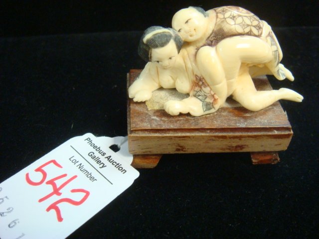 SIGNED JAPANESE IVORY CARVED NETSUKE COUPLE:: SIGNED JAPANESE IVORY CARVED NETSUKE COUPLE: Erotic, Anatomically Correct, Amorous Couple On Wooden Plinth. 2 3/16"L . Due to Pending US Government Rule changes on the sale of Ivory the following Spec