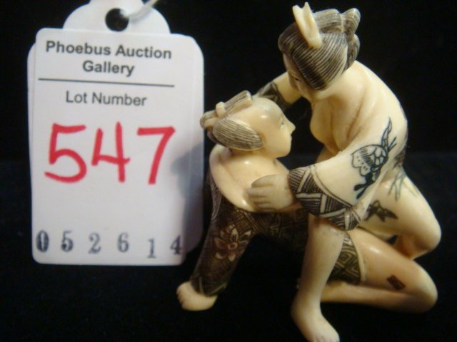 SIGNED CARVED IVORY EROTIC NETSUKE COUPLE:: SIGNED CARVED IVORY EROTIC NETSUKE COUPLE: Anatomically Correct and Very Amorous Two Parter. Ink Stained Highlights on Hair and Incised Garments. Signed on Man's Leg. 1 3/4"T. Due to Pending US Govern