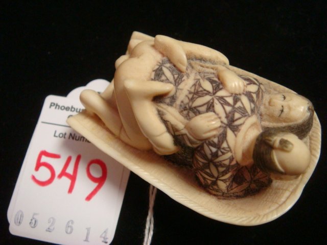 SIGNED CARVED IVORY EROTIC NETSUKE BASKET COUPLE:: SIGNED CARVED IVORY EROTIC NETSUKE BASKET COUPLE: This Bawdy Couple Has Ink Stained Incised Clothing. Both Are Reclining on Basket, Limbs Contorted in Ecstasy. Done in Ukiyo-E Genre of Sexually Expres