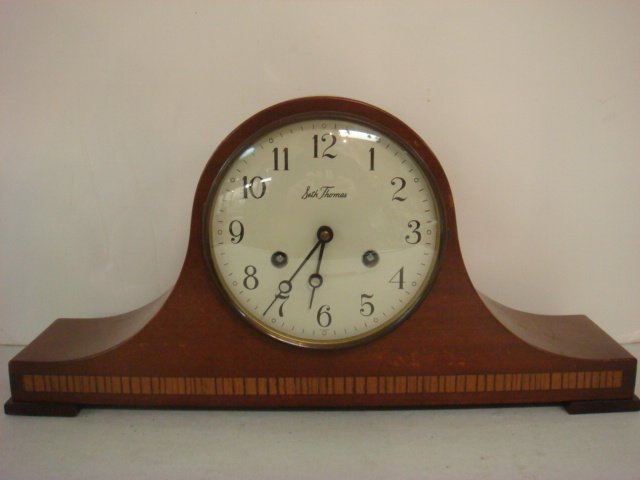 SETH THOMAS Mahogany Mantle Clock:: SETH THOMAS Mahogany Mantle Clock: Brass Surrounds Metal Face, Convex Glass on Door, Wood Inlay Near Bottom. Has Key and Pendulum; #6402. 8 1/4T x 16 3/4"W. (75-100)