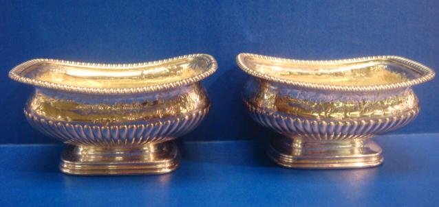 Pair of PAUL STORR Sterling Silver Master Salts:: Pair of PAUL STORR Sterling Silver Master Salts: Georgian Silver with Crowned Leopard Mark for London. Date Mark of 1816. Pedestal Base with Reeded Sides, Gadrooned Rim and Chased Floral Border. 2 1/8