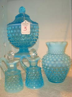 Four FENTON Glass Blue Opalescent Hobnail Pieces:: Four FENTON Glass Blue Opalescent Hobnail Pieces: Footed Candy Dish with Lid is 7 1/4"T, Vase with Star Crimped Top is 5 1/4"T, Pair of 4 1/2"T Cruets with Crown Stoppers. (140-240)