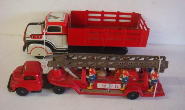 Vintage Tin Litho MARX Truck & Japan Fire Engine:: Vintage Tin Litho MARX Truck & Japan Fire Engine: Marx Farm Stake Delivery Truck is 13"L. Played With Condition with Scratches, Front Grill Loose. Back Wheels Slide. Made in Japan Ladder Truck is 14 1