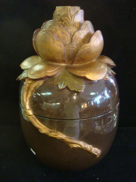 Large, Glazed Ceramic Jar with Lotus Flower Lid:: Large, Glazed Ceramic Jar with Lotus Flower Lid: Brown Mottled Gloss Glaze Body with Large Lotus in Burnished Gold and Green with Stem Extending Down onto Base. 11"D, 18 1/2"T. Paper Label 1981 Chapma