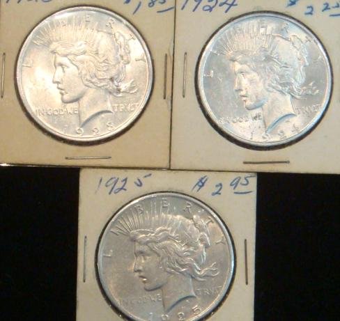 Two PEACE US SILVER DOLLAR; 1923, 1924 & 1925:: Two PEACE US SILVER DOLLAR; 1923, 1924 & 1925: All in MS60+ Condition, Some Bag marks. 90% Pure Silver. All in Paper and Cellophane Fold over Holders (100-150)