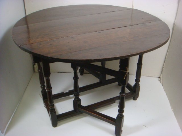Traditional Oak Gate Leg Table:: Traditional Oak Gate Leg Table: Round Top Table When Opened Completely, Swing Out Legs, Single Box Stretcher and Drawer at Each Ends. Turned Wood Legs Ending In Ball Feet. 29"T x 40"L x 13 1/2"W Exten