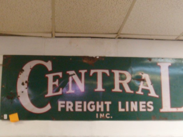 Metal Painted Advertising Sign "CENTRAL FREIGHT":: Metal Painted Advertising Sign "CENTRAL FREIGHT": 24" X 73" White Lettering on Green Ground "CENTRAL FREIGHT LINES, INC." Minor Rust and A Few Shotgun Pellet Holes. A Texas Company since 1925. (100-25