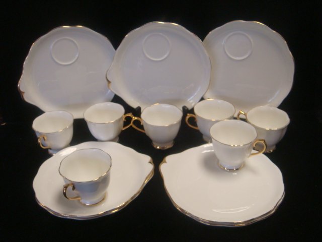 ROYAL ALBERT "Val Door" Luncheon Set:: ROYAL ALBERT "Val Door" Luncheon Set: Eleven 8 1/4"D Tab Plates with Cup Ring. Ten Footed Cups. White with Gold Rims. (40-60)