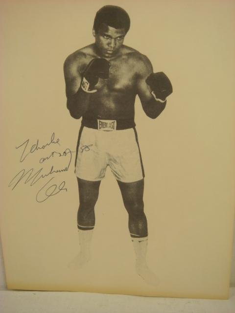 Autographed MUHAMED ALI Photograph:: Autographed MUHAMED ALI Photograph: Cassius Marcellus Clay, JR. 01/1942. Black & White 8 X 10 Glossy Signed Photo, Inscribed. (100-200)
