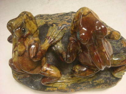 Pair of Carved Frogs on Rock:: Pair of Carved Frogs on Rock: Carved from Ocean Jasper. Each Frog has Applied Glass Eyes. Artist Signed AN. 6" X 3 1/2" X 3 5/8". 3 1/2 LBS. (400-600)