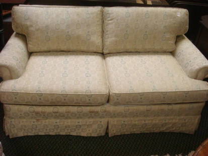 Traditional Upholstered Sofa:: Traditional Upholstered Sofa: Loose Seat and Back Fitted Cushions. Rolled Arms, Box Pleat Tailored Skirt. Beige Upholstery with Blue, Gold, and Gray Accents. 58"L 28"T at Back. (140-240)