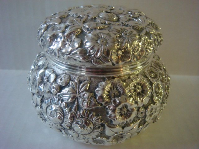 A.G. SCHULTZ Repousse Dresser Box:: A.G. SCHULTZ Repousse Dresser Box: Ca 1899-1950. Fully Chased Box and Lid is 3 1/4"T. Retailed by Woodley & Co. Schultz "Hand" Mark on Bottom. 2 Small Holes in Lid. (200-300)