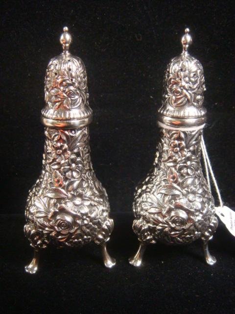 Pair of S KIRK Sterling Repousse Pepper Shakers:: Pair of S KIRK Sterling Repousse Pepper Shakers: Covered in Lush Floral Pattern, Resting on Acanthus Leaf and Paw Feet. Stamped S. Kirk & Son, Sterling 58. 4 1/2"T. 5.8 oz. (300-400)