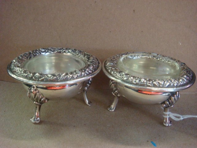Pair of S KIRK Repousse Sterling Open Salts:: Pair of S KIRK Repousse Sterling Open Salts: Each with Three Acanthus Leaf and Paw Feet, Floral Repousse Rims and Glass Liners. Stamped S. Kirk & Son, Sterling 58. 3.72 oz., 2 3/4"D, 1 5/8"T. (300-400