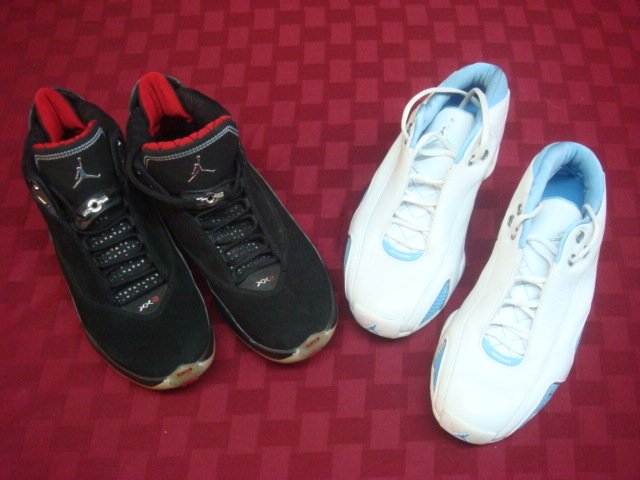 Two Pairs of Air Jordans:: Two Pairs of Air Jordans: Both Size 8 (41 Europe). White Pair with Sky Blue Trim and "23". Black Pair with Silver Fittings and Mike in flight. Both New, not Worn. (100-200)