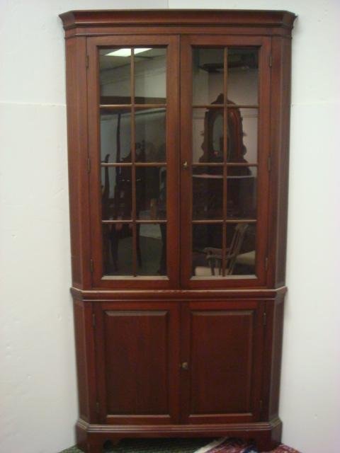 Mahogany Glass Front Corner Cabinet:: Mahogany Glass Front Corner Cabinet: Double Door with Solid Pane of Glass Divided by Mullions Open to 4 Adjustable Shelf Interior Solid Panel Lower Doors with 2 Shelf Interior. Overhang Ogee Cornice. 