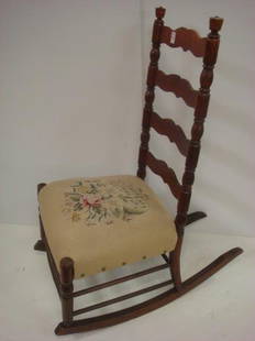 Ladderback Rocker with Needlepoint Seat:: Ladderback Rocker with Needlepoint Seat: Armless Rocker with Finial Topped Ring and Sausage Stiles and Legs. Sculpted Horizontal Splats with Double Box Stretcher. Beige Ground Floral Seat. 40"T at