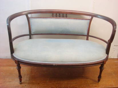 Blue Velvet Upholstered Settee:: Blue Velvet Upholstered Settee: Mahogany Rounded Back & Arms, Open Sides W/Upholstered Section Under 5 Short Turned Wood Spindles Over Oval Seat. Concave Carved Surround & is Supported By Sheraton