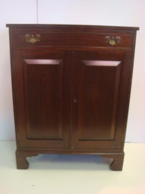 BIGGS Mahogany Side Cabinet:: BIGGS Mahogany Side Cabinet: 20th C. One Drawer Over Double Raised Panel Cabinet Doors with Key and Single Shelf Interior. Federal Style Brass Bail Pulls. Carved Bottom Apron with Bracket Feet. 36"T, 