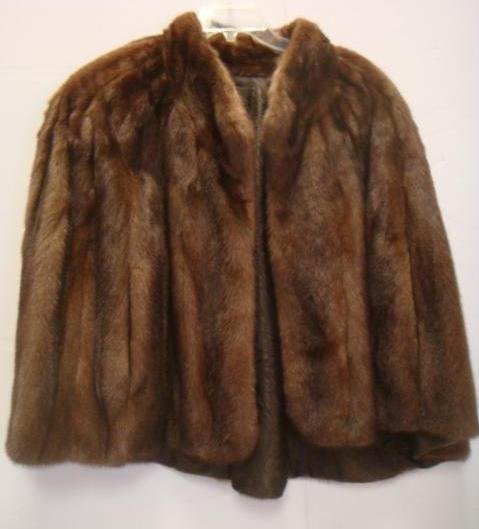 Sable Mink Swing Cape From Lowenthal:: Sable Mink Swing Cape From Lowenthal: Stand Up Collar, Slit Side Arm Holes, Vertical Pelts, Lined Inside Pockets. Name Stitched at Hem. Single Hook Closure, 20" Shoulder to Hem. (150-250)