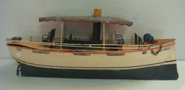 Painted Metal "POLARIS" Toy Boat:: Painted Metal "POLARIS" Toy Boat: 19" Long with Canopy, Deck Chairs, Steam Engine, Capstan and Steering Wheel. Looks like the "African Queen" of Hepburn/Bogart Fame. (100-250)