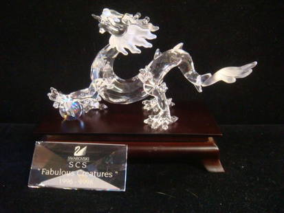 SWAROVSKI Crystal Fabulous Creatures Dragon:: SWAROVSKI Crystal Fabulous Creatures Dragon: G Stamey Designer, Issued 1999. Includes Wooden Stand, Iridescent Ball and Plaque. Original Box. The Dragon is the Symbol of Good Luck in China for the