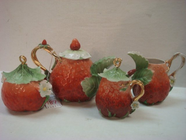 Strawberry Motif Tea & Condiment Four Piece Set:: Strawberry Motif Tea & Condiment Four Piece Set: White Porcelain Set includes Tea Pot, Creamer, Open Sugar, and Covered Condiment Pot with Strawberry Spoon. (-)