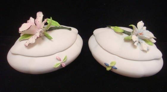 Two CAPO DI MONTE Bisque Trinket Boxes with Orchids:: Two CAPO DI MONTE Bisque Trinket Boxes with Orchids: Oval Boxes with Applied Orchids on Top, One Blue, One Pink, with Stems and Leaves on Tops and Sides. Capo di monte Mark on Bottoms. 4"T, 6"L. 