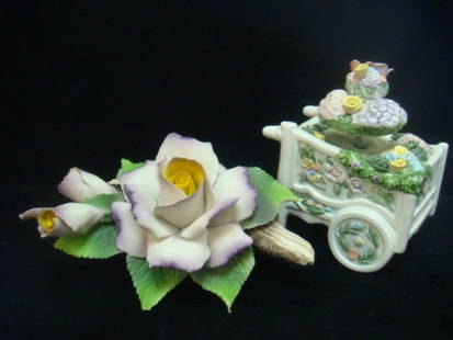 CAPODIMONTE Bisque Rose and SCHMID Ceramic Music Box:: CAPODIMONTE Bisque Rose and SCHMID Ceramic Music Box: White with Purple Rose and Buds on Bisque Log. Blue N with Crown Made in Italy Mark. 4 1/2"T, 7"W. Some Minor Chips. Schmid Sri Lanka Flower Cart