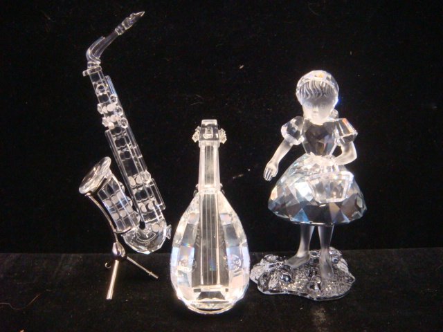 SWAROVSKI Crystal Girl w/Basket, Lute and Saxophone:: SWAROVSKI Crystal Girl w/Basket, Lute and Saxophone: Girl with Separate Basket and Flowers at Base with Crystal Centers is 3 1/2"T. Lute on Metal Stand is 3 1/4"T. Saxophone on Metal Stand with "Pearl