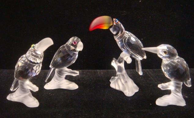 Four SWAROVSKI Crystal Birds on Branches: Parrot with: Four SWAROVSKI Crystal Birds on Branches: Parrot with Iridized Eyes is 2 1/4"T. Toucan with Colorful Beak is 2 3/4"T. Kingfisher is 2 1/4"T. Up in Trees Toucan with Frosted Beak is 2 3/8"T. Original B