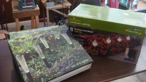 Three Premium Outside Light Sets:: Three Premium Outside Light Sets: 12 Solar Champagne Lights New in Box, and 6 Malibu Hybrid Lights with Plug in Back up. All Three Never Opened. (100-200)