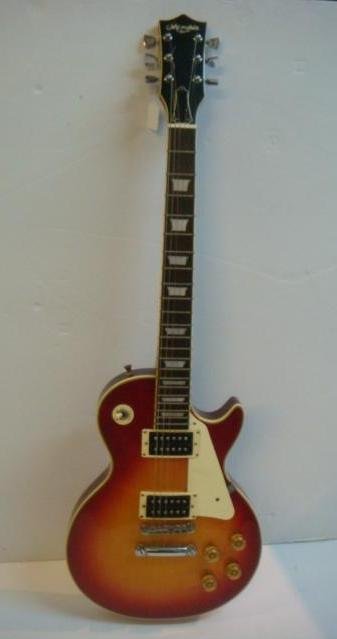MEMPHIS Rhythm Electric Guitar and Case:: MEMPHIS Rhythm Electric Guitar and Case: Mother of Pearl Insets on Neck, Wooden Body. These Were Made as Pseudo "Les Paul's", in the late 1980's. (200-400)