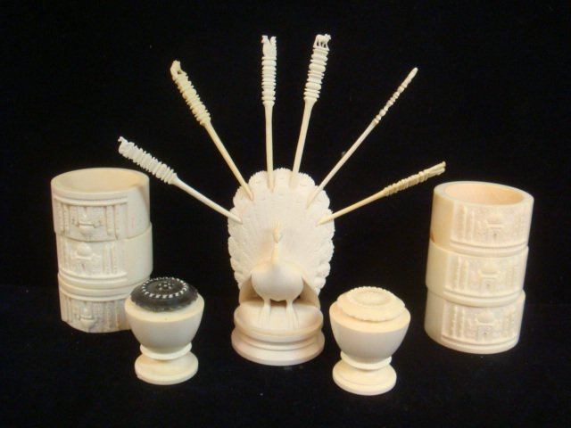 Nine Carved Ivorine Table Top Items:: Nine Carved Ivorine Table Top Items: Six Taj Mahal Carved Napkin Rings are 2"D. Salt and Pepper Shakers are 1 3/4"T. Peacock is 3 1/2"T and Holds 6 Animal Carved Cocktail Picks. (160-240)