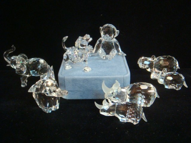 Nine Swarovski Crystal African Animals:: Nine Swarovski Crystal African Animals: Chimpanzee is 1 3/4"T. 2 3/4"T Large Hippo. 2"L Baby Hippo. 2 7/8"L Large Rhino. 2 1/4"L Baby Rhino. 2 1/2"T Trunk Up Elephant. 2 1/8"T Elephant. 1 1/4"T Baby E