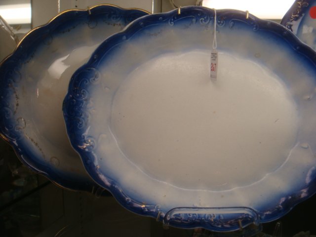 Pair of La France Porcelain Flow Blue Platters:: Pair of La France Porcelain Flow Blue Platters: Sebring, Ohio, 1900-1916. Blue Rims with Gold Floral Swags and Rims. 15 1/4" X 12". (100-200)