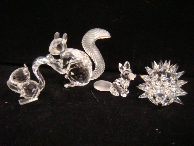 Four SWAROVSKI Crystal Woodland Creatures:: Four SWAROVSKI Crystal Woodland Creatures: Limited Edition 10th Anniversary Squirrel is 2 3/8"T. Squirrel with Nut is 1 3/4"T. Sitting Fox with Frosted Tail and Muzzle is 1 1/4"T. Hedgehog is 1 1 /4"T