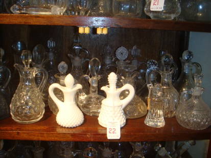 Collection of Pressed Glass Cruets, CA 1930:: Collection of Pressed Glass Cruets, CA 1930: 2 Milk Glass & 1 Fostoria American. Twenty Plus Glass Cruets. Most Have Stoppers & Some Have Their Original Labels. Various Sizes. Set that Eclectic Table