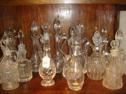 Fourteen Large Pressed Glass Cruets, CA 1930:: Fourteen Large Pressed Glass Cruets, CA 1930: Includes Etched, Pressed and Cut Glass of Various Styles and Sizes. Perfect for the Salad Course at your next Formal Dinner. (75-100)