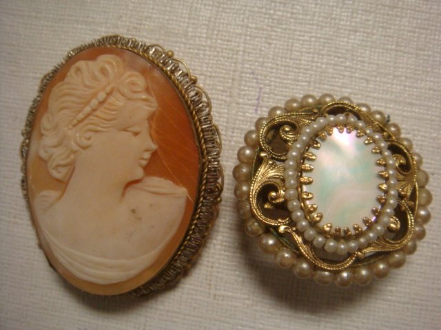 Shell Cameo Pendant and Mother of Pearl Pin:: Shell Cameo Pendant and Mother of Pearl Pin: Left Facing Profile w/Short Hair & Bead Hair Band. Pierced Gold Tone Setting Surrounds Carved Cameo Bust. It Measures 1 3/4"Long. MOP Oval Edged Gold Tone 